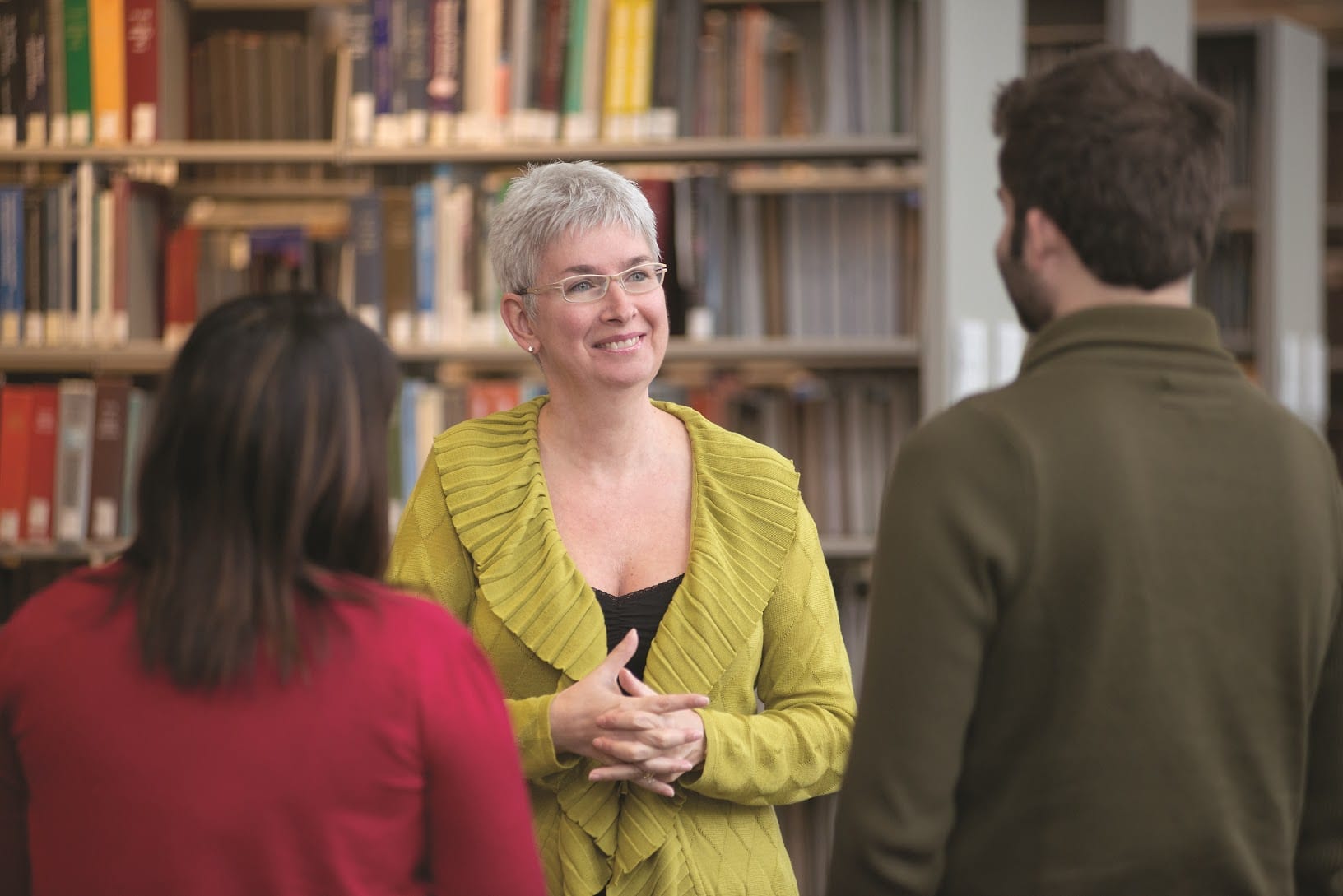 Professor Moren Levesque smiling and speaking with students