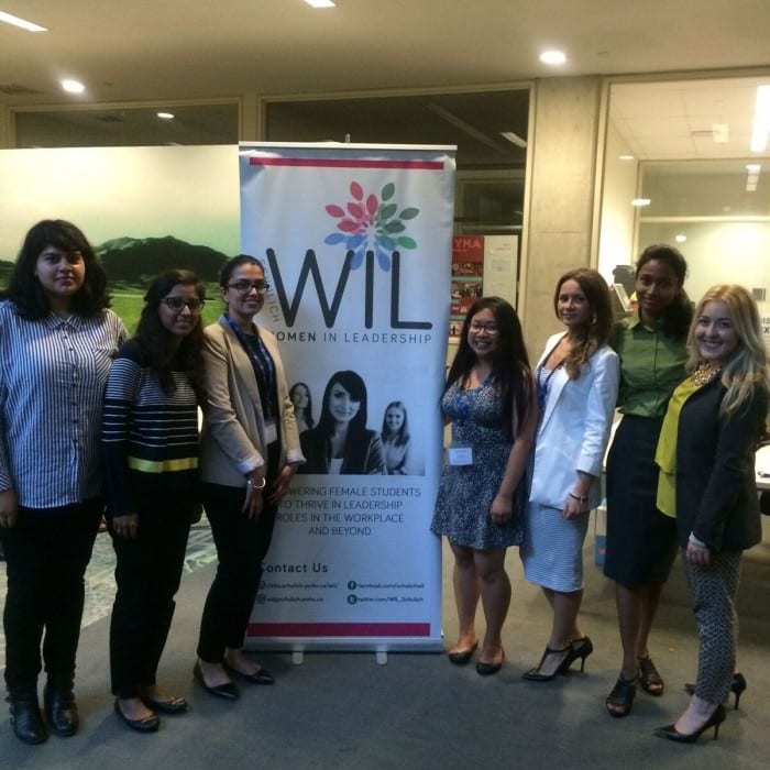Photo of female student members of Women in Leadership standing together and smiling