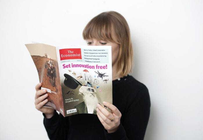 Woman reads Economist magazine