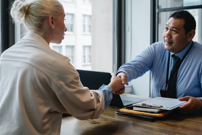 Woman and man shaking hands business deal