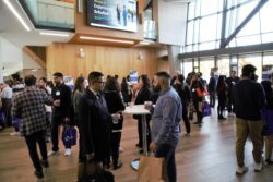 Experience Schulich Event with people standing around chatting in McEwen building