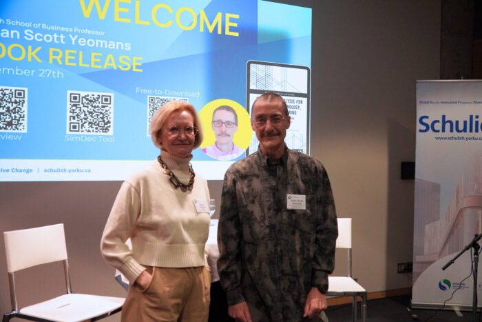 Profs Fischer and Yeomans at launch in front of screen