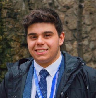 Portrait of a young man wearing a suit and tie outdoors.